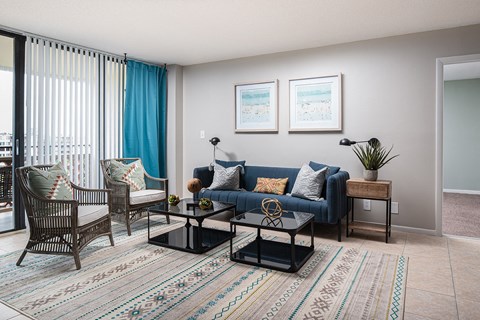 a living room with a blue couch and two chairs